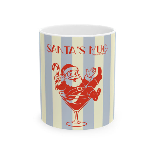 A white ceramic mug featuring a retro-style holiday design with vertical light blue and cream stripes, red text reading 'SANTA'S MUG', and an illustration of Santa sitting in a martini glass holding a candy cane.