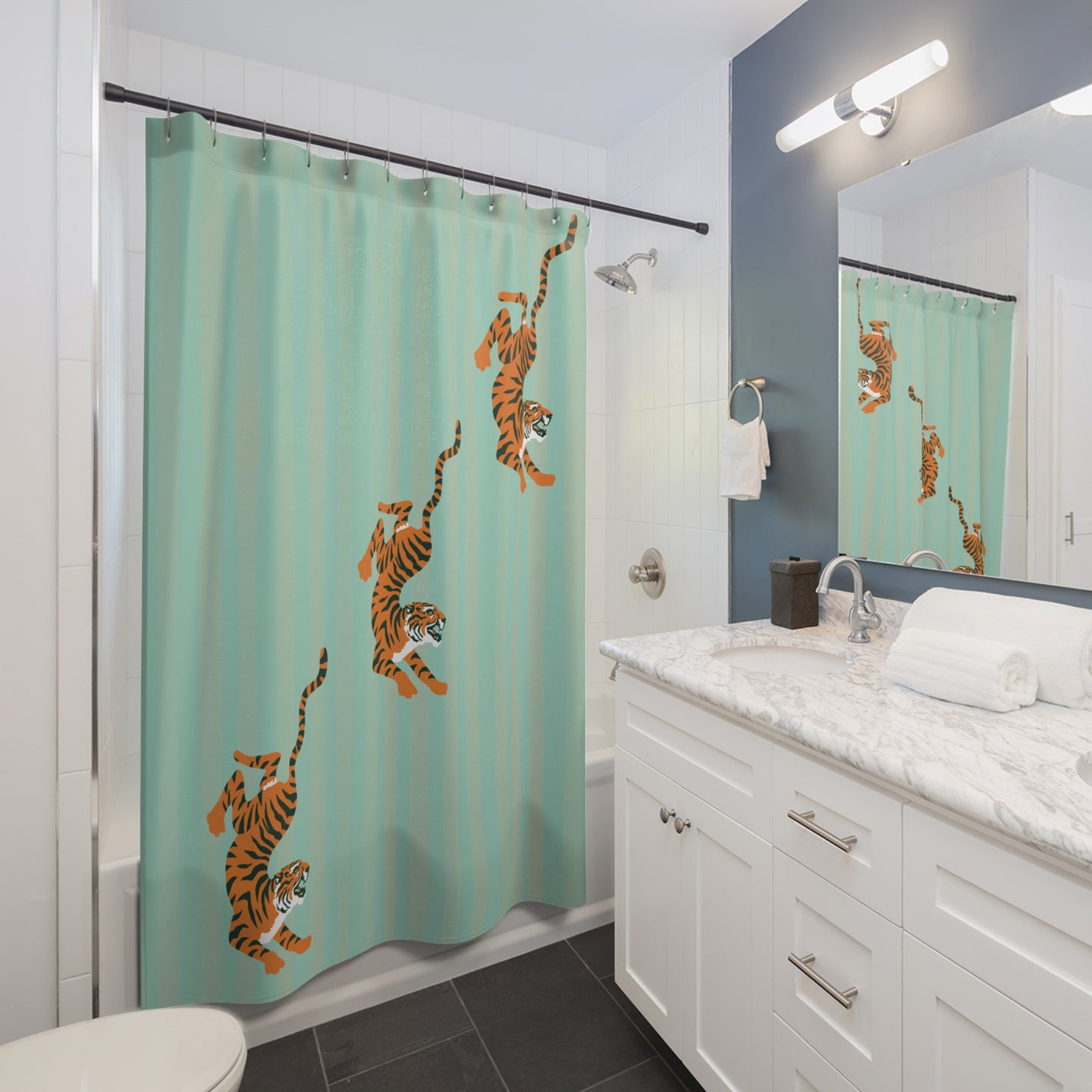Bathroom with a shower curtain featuring tiger designs on a teal background.