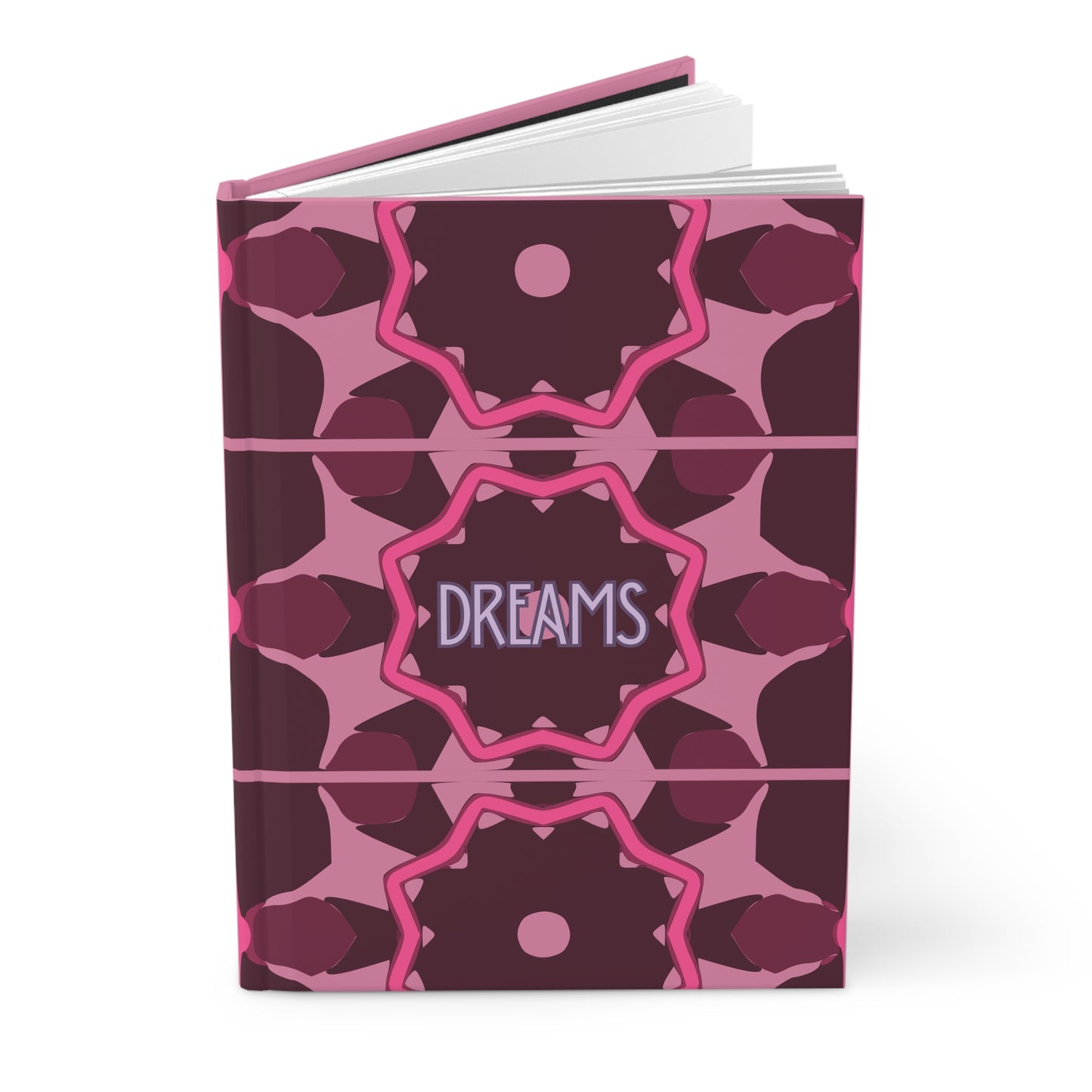 Notebook with pink geometric pattern and 'DREAMS' text on a white background