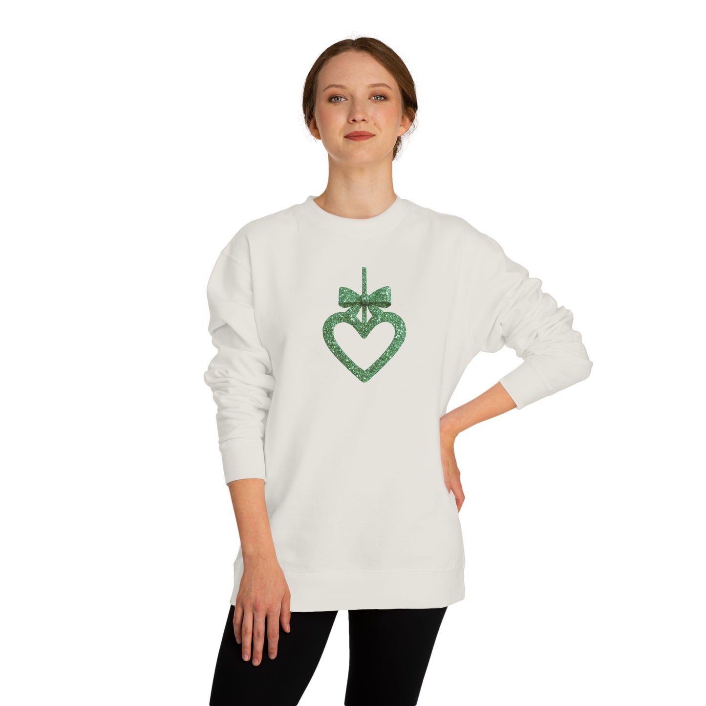 Woman wearing a white sweater with a green heart design on a white background