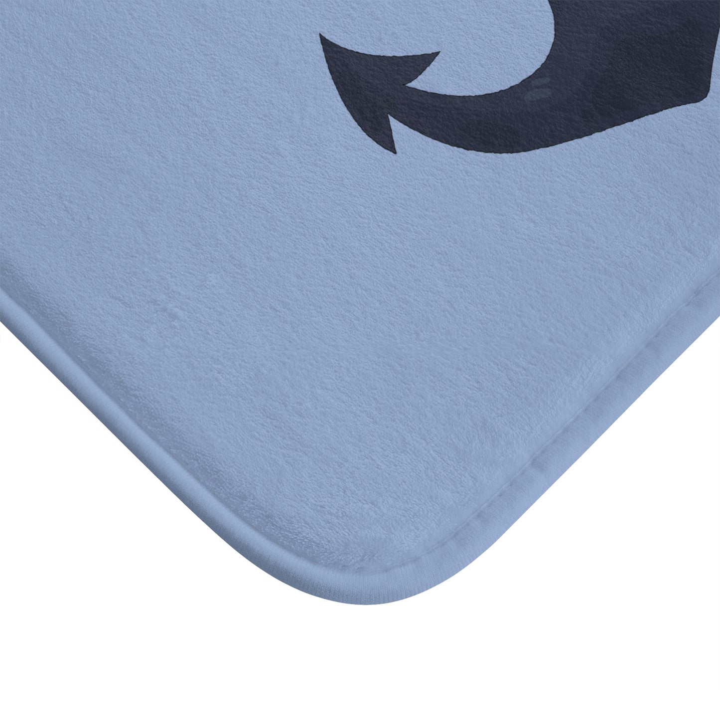 Blue bath mat with a black arrow design on a white background