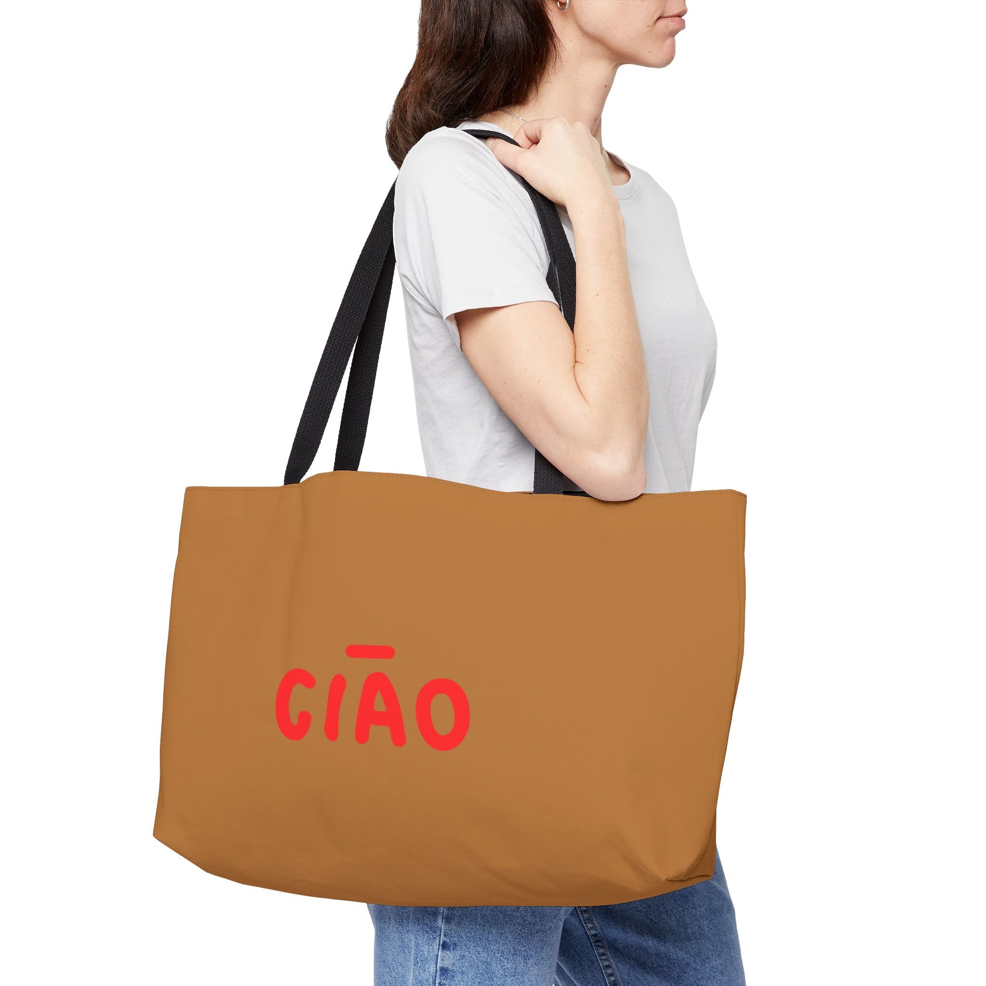 Person holding a brown tote bag with 'CIAO' in red text on a white background