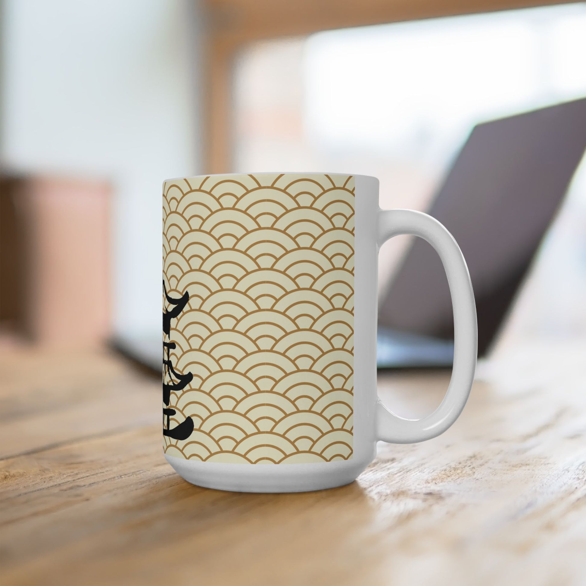 White mug with gold wave pattern and black text on a wooden surface