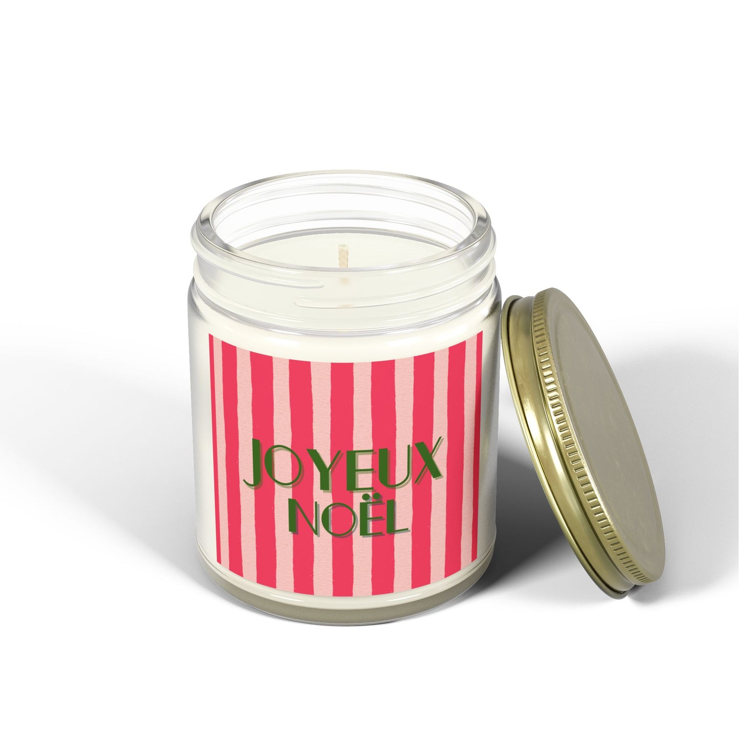 Joyeux Noel Candle in a jar with a pink and white striped label and gold lid on a white background