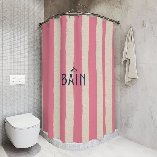 Shower curtain with pink and beige stripes and 'Le Bain' text in a bathroom setting.