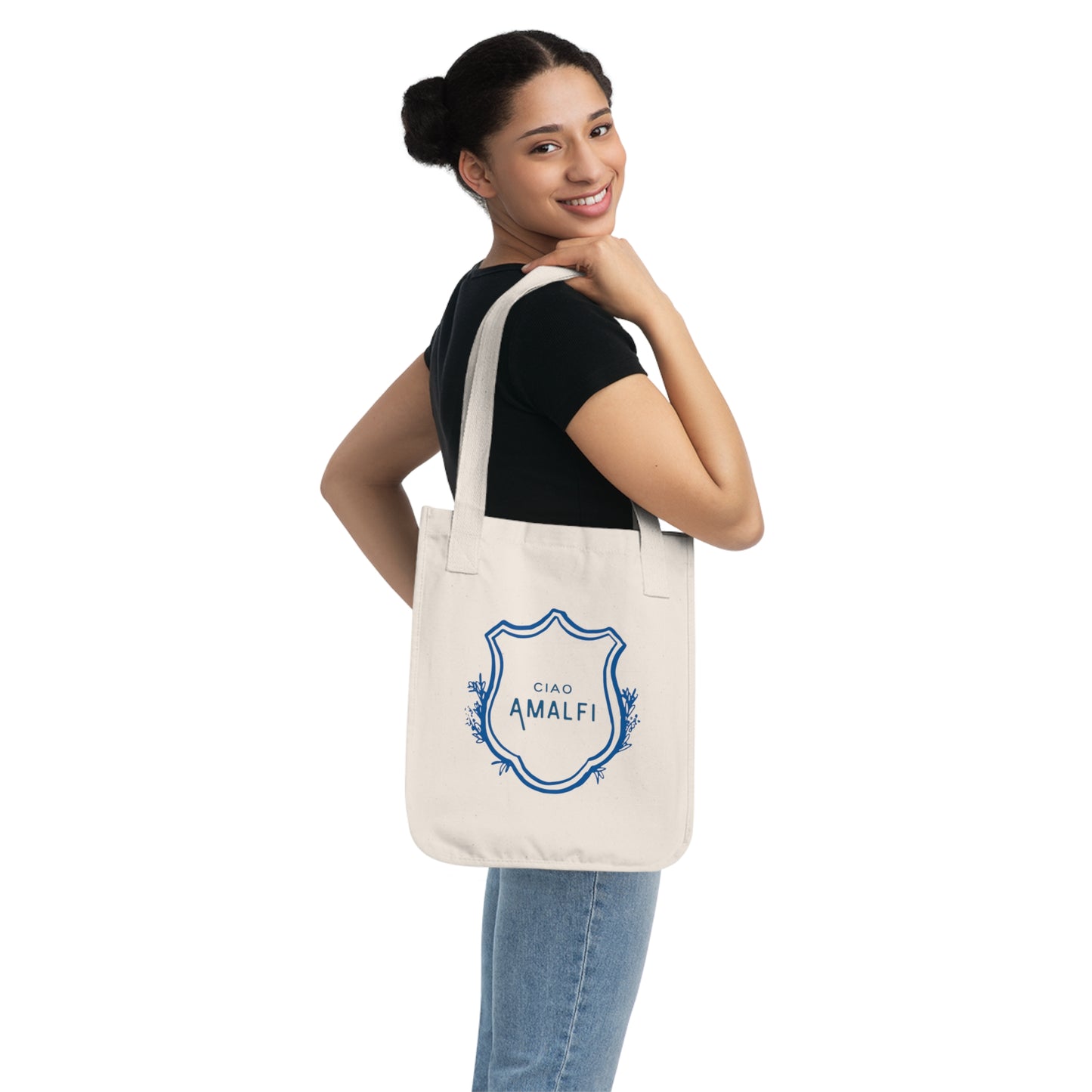 Woman holding a tote bag with floral design and text on a white background