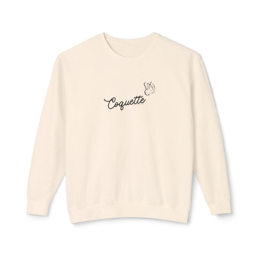 Beige sweater with 'Coquette' text on a white background