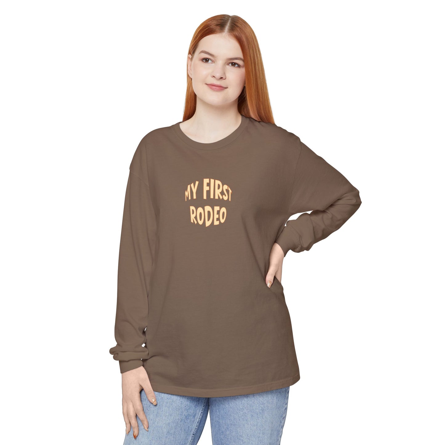 Woman wearing a brown long-sleeve shirt with 'My First Rodeo' text on a white background