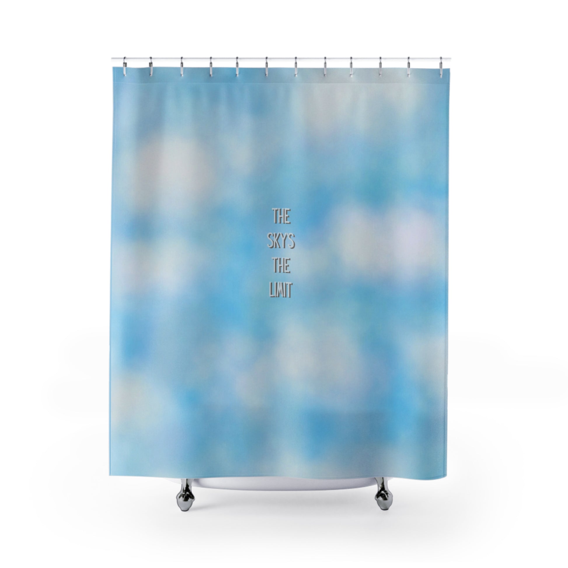 Shower curtain with a blue sky and cloud pattern and 'The Sky's The Limit' text.