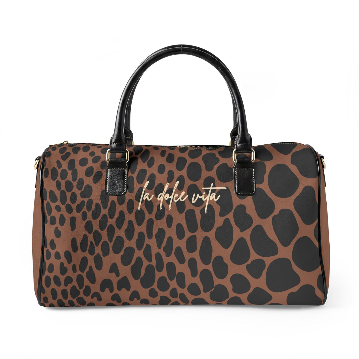 A brown and black leopard print handbag with black leather handles and gold-tone hardware, featuring the text 'la dolce vita' in gold cursive across the front, set against a plain white background.