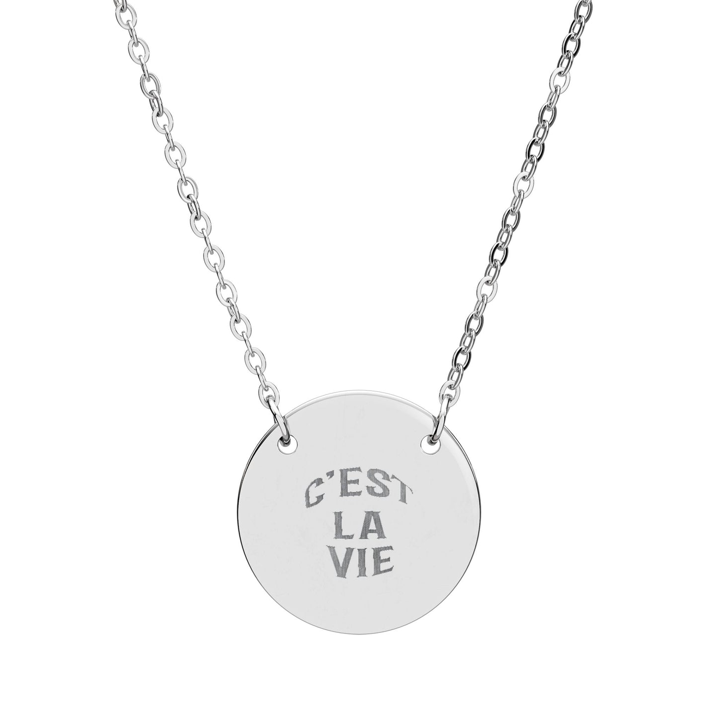Silver necklace with a round pendant engraved with 'C'EST LA VIE' on a white background