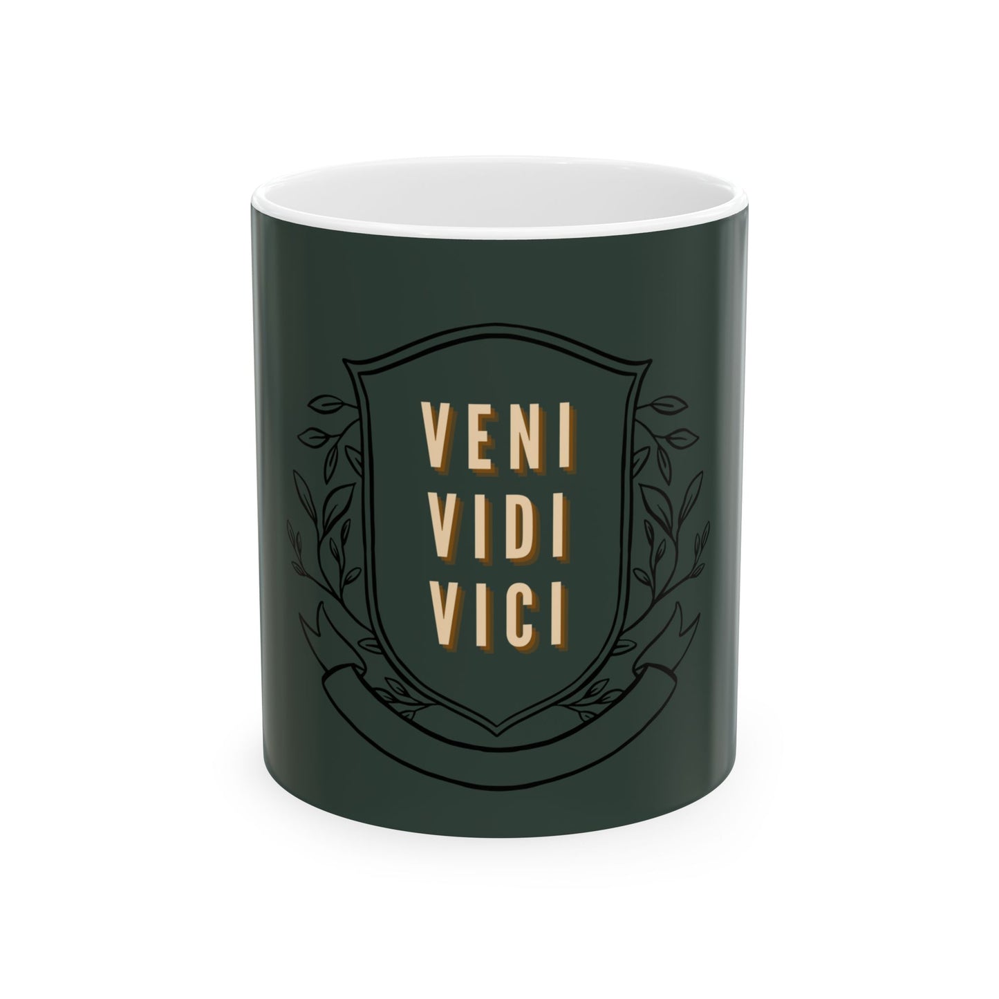 A dark green ceramic mug with a white interior, featuring a black shield emblem with the words 'VENI VIDI VICI' in gold lettering and decorative leaf motifs.