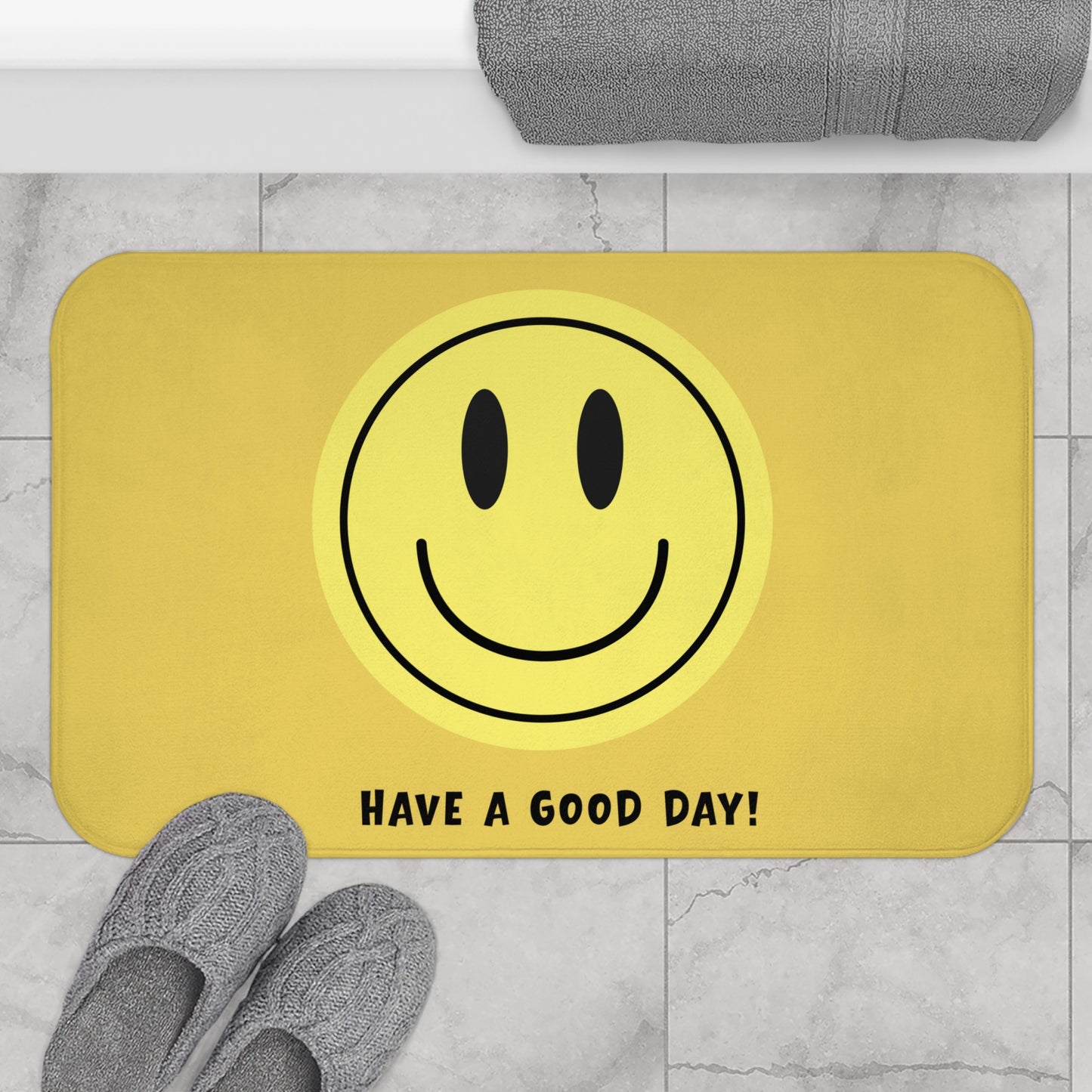 Yellow doormat with smiley face and 'Have a Good Day!' text on a marble floor.