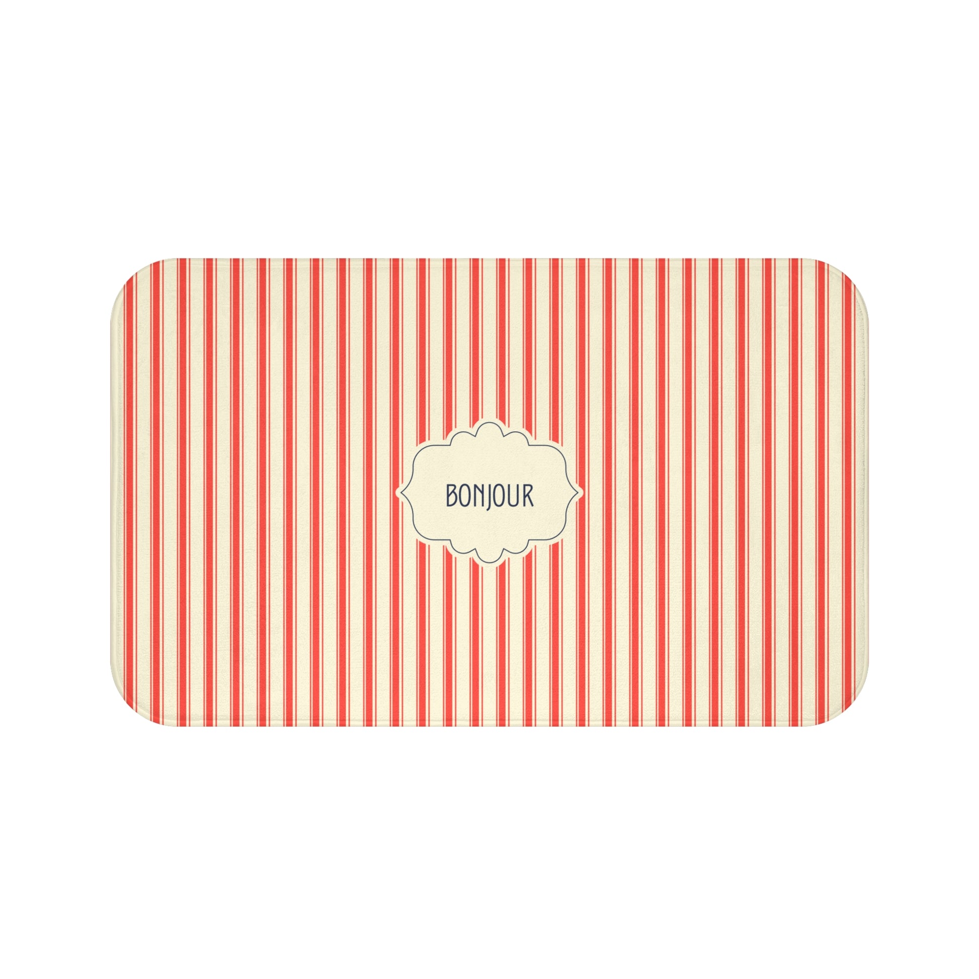 A bath mat with rounded corners, featuring vertical red and cream stripes and a central cream label with the word 'BONJOUR' in black text.