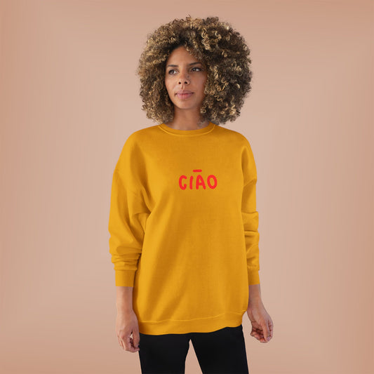 Woman wearing a yellow sweatshirt with 'Cóñ' in red text on a beige background