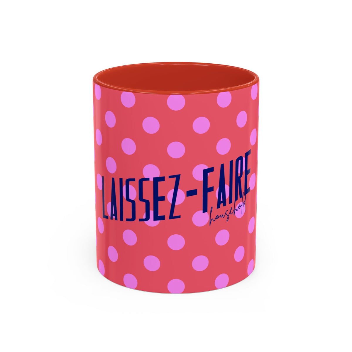 A cylindrical mug with a coral red exterior patterned with pink polka dots and dark blue text reading 'LAISSEZ-FAIRE' with a smaller 'housman' signature, shown on a plain white background.