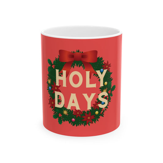 A red ceramic mug featuring a festive Christmas wreath design with the words 'HOLY DAYS' in cream lettering, set against a plain white background.