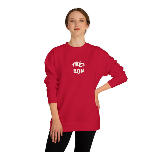 Person wearing a red sweatshirt with 'TRES BON' text on a white background