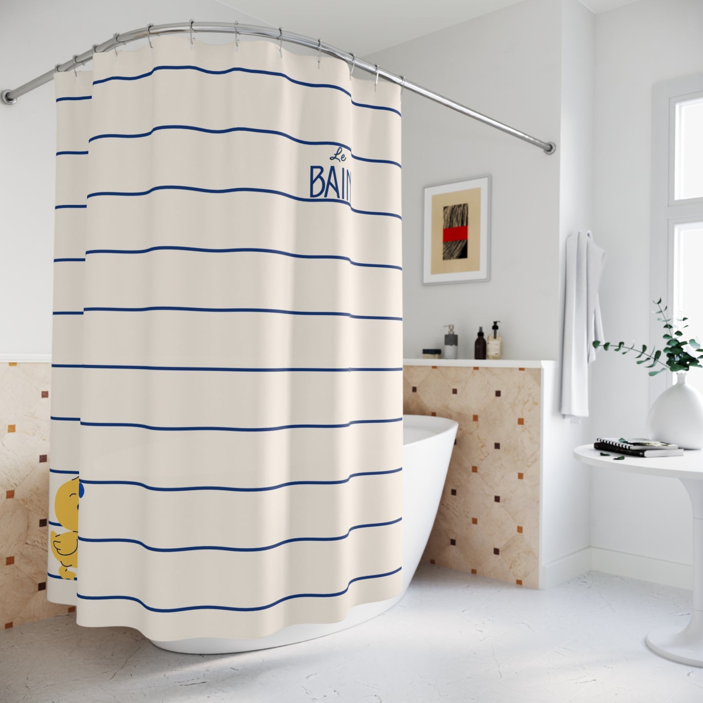 A shower curtain with horizontal blue stripes on an off-white background, featuring the word 'BATH' in blue text and a small yellow duck illustration near the bottom left. The curtain is shown hanging in a bright, modern bathroom next to a bathtub.
