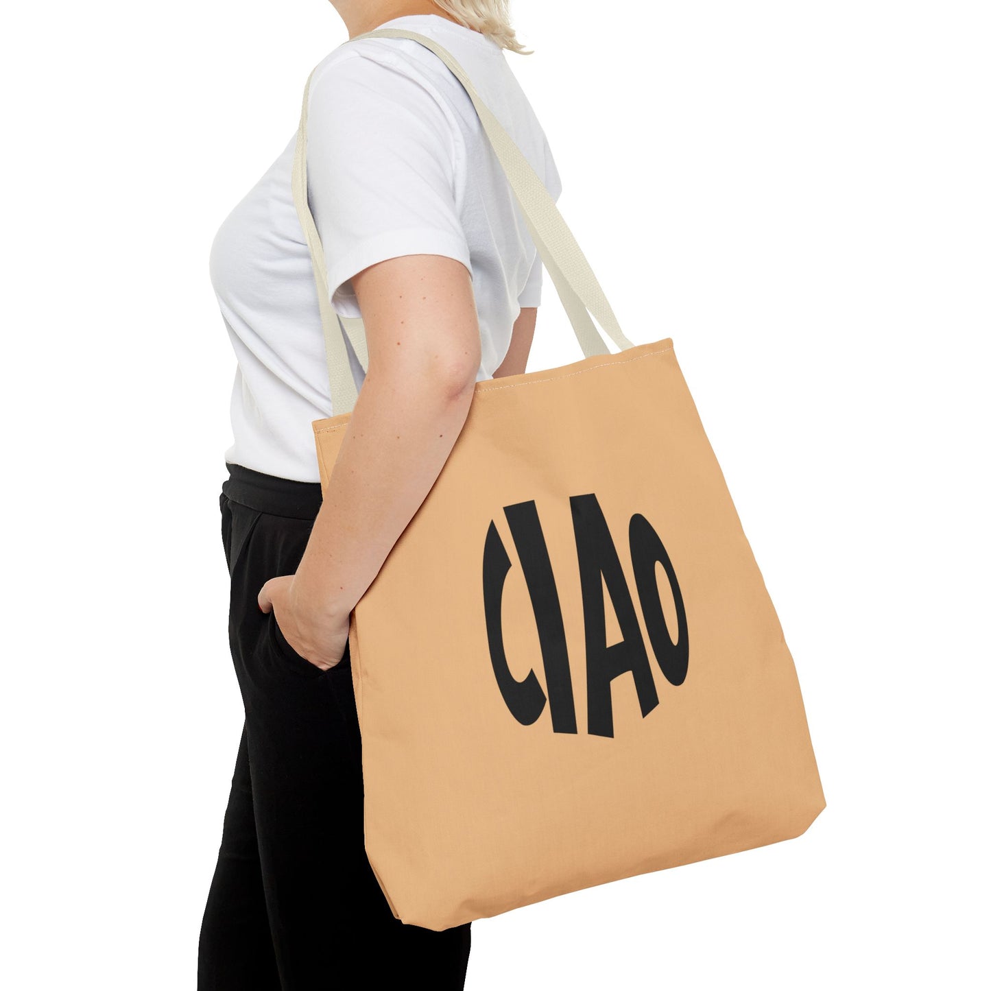Person holding a beige tote bag with 'CHAO' printed on it against a white background
