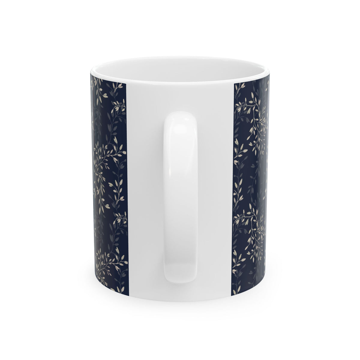 A white ceramic mug with vertical navy blue panels on the sides featuring a delicate beige floral and leaf pattern, shown against a plain white background.