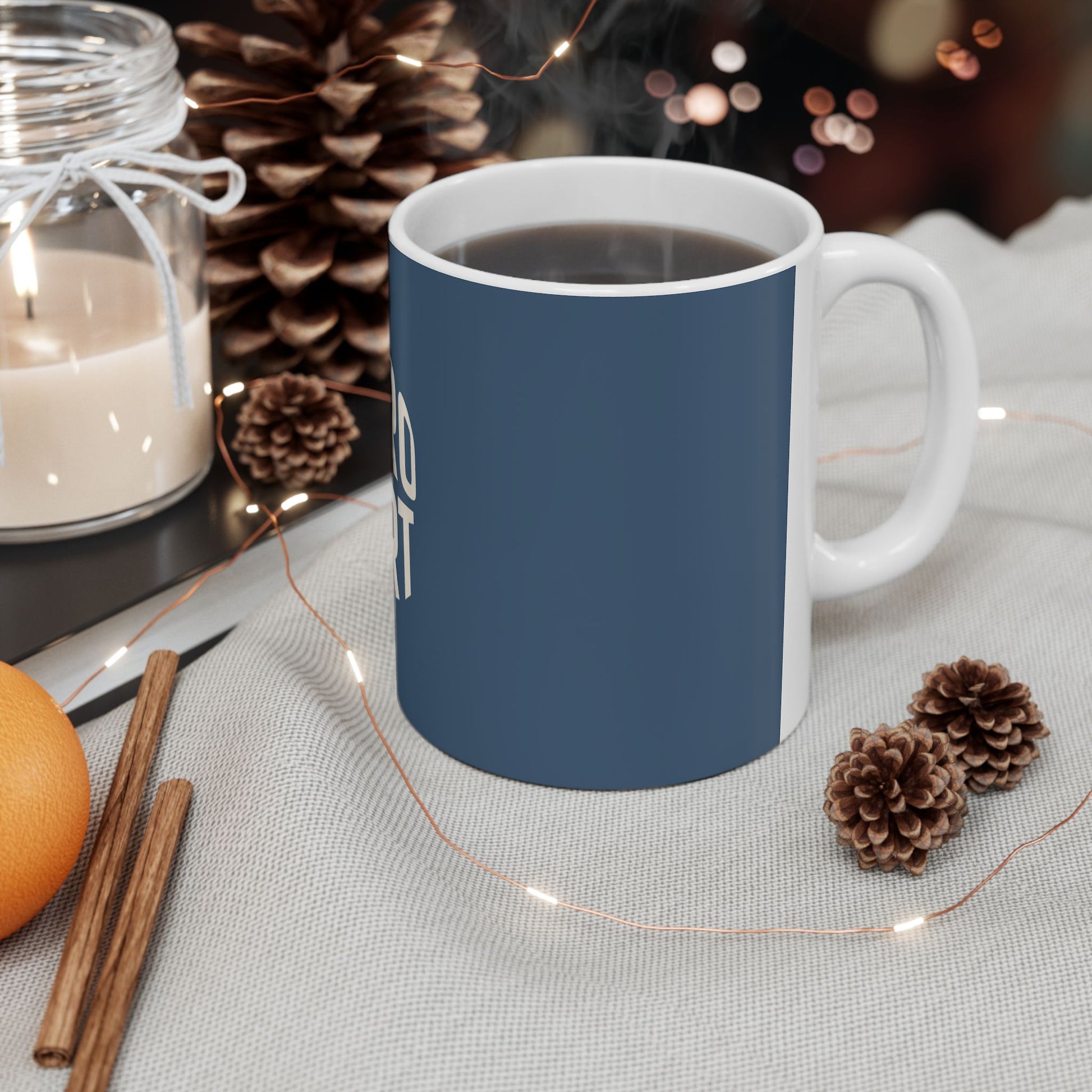 Blue mug with white handle on a table with decorative items