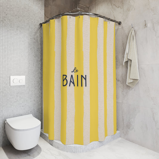Shower curtain with yellow and beige stripes and 'Le Bain' text in a bathroom setting.