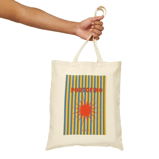 Tote bag with 'Portofino' design held by a hand on a white background