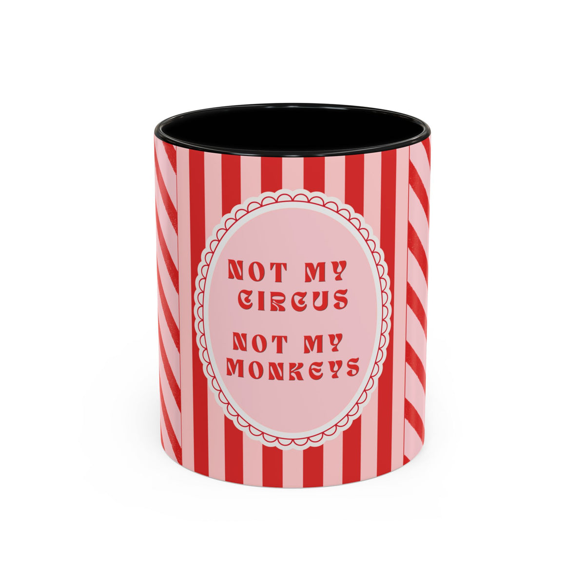 A ceramic mug with a red and pink striped design, featuring a central pink oval with the text 'NOT MY CIRCUS NOT MY MONKEYS' in red. The mug has a black interior and is photographed on a clean white background.