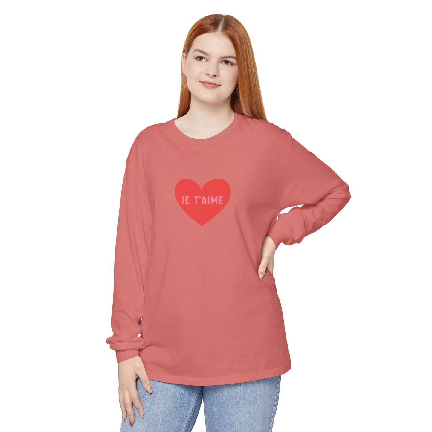 Woman wearing a red long-sleeve shirt with a heart design and text on a white background