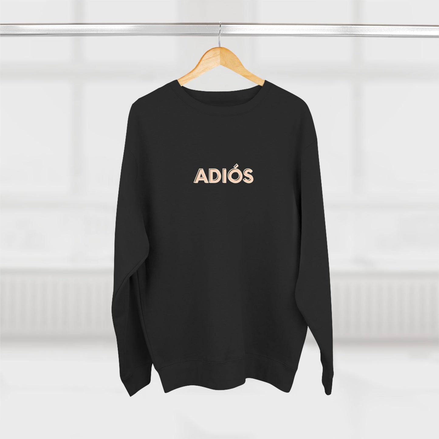 Black sweatshirt with 'ADIOS' text on a hanger against a white background
