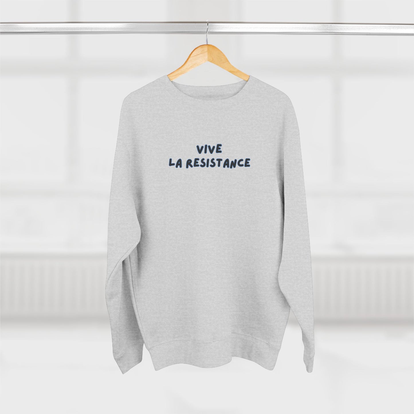 Gray sweatshirt with 'Vive La Resistance' text on a hanger against a white background