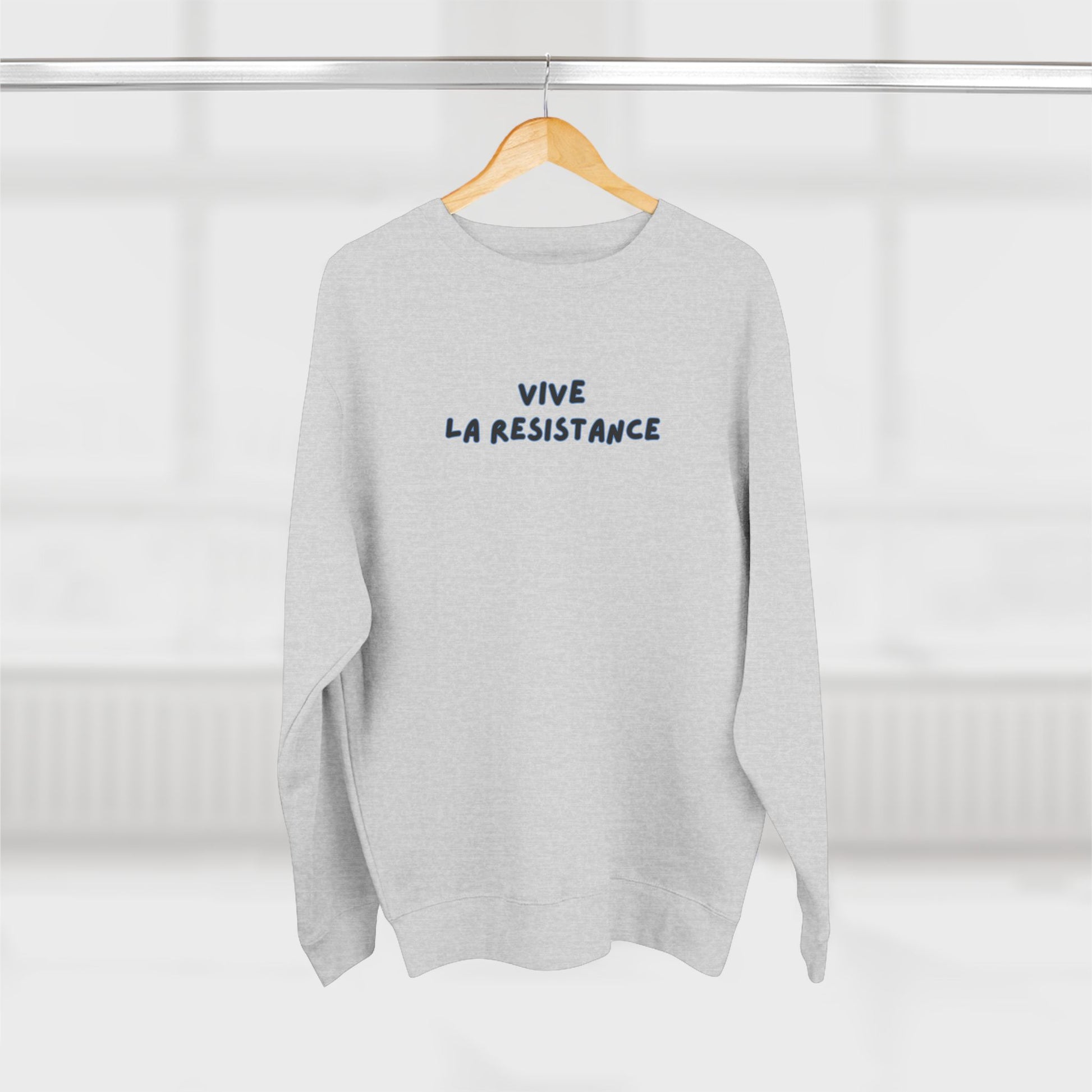 Gray sweatshirt with 'Vive La Resistance' text on a hanger against a white background