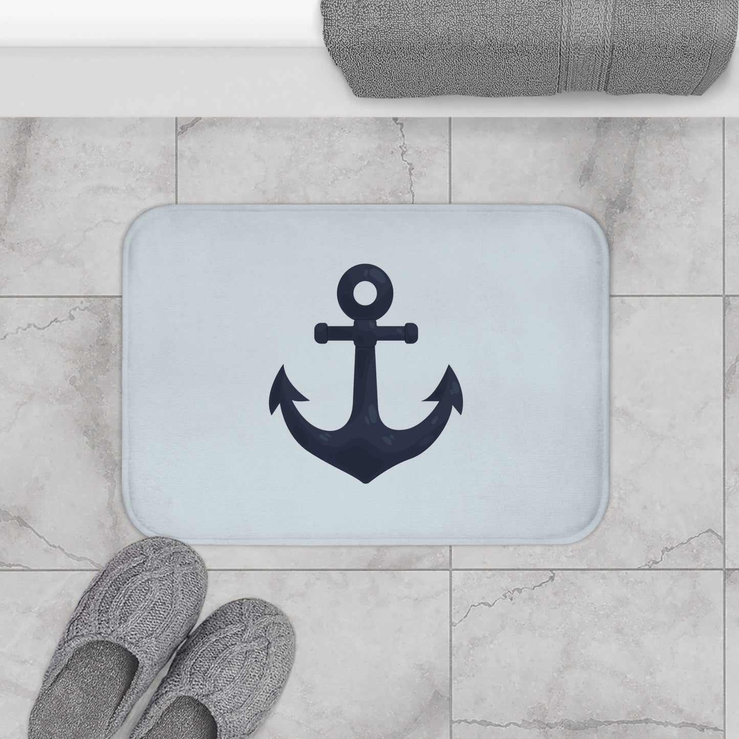 Bath mat with anchor design on a tiled bathroom floor
