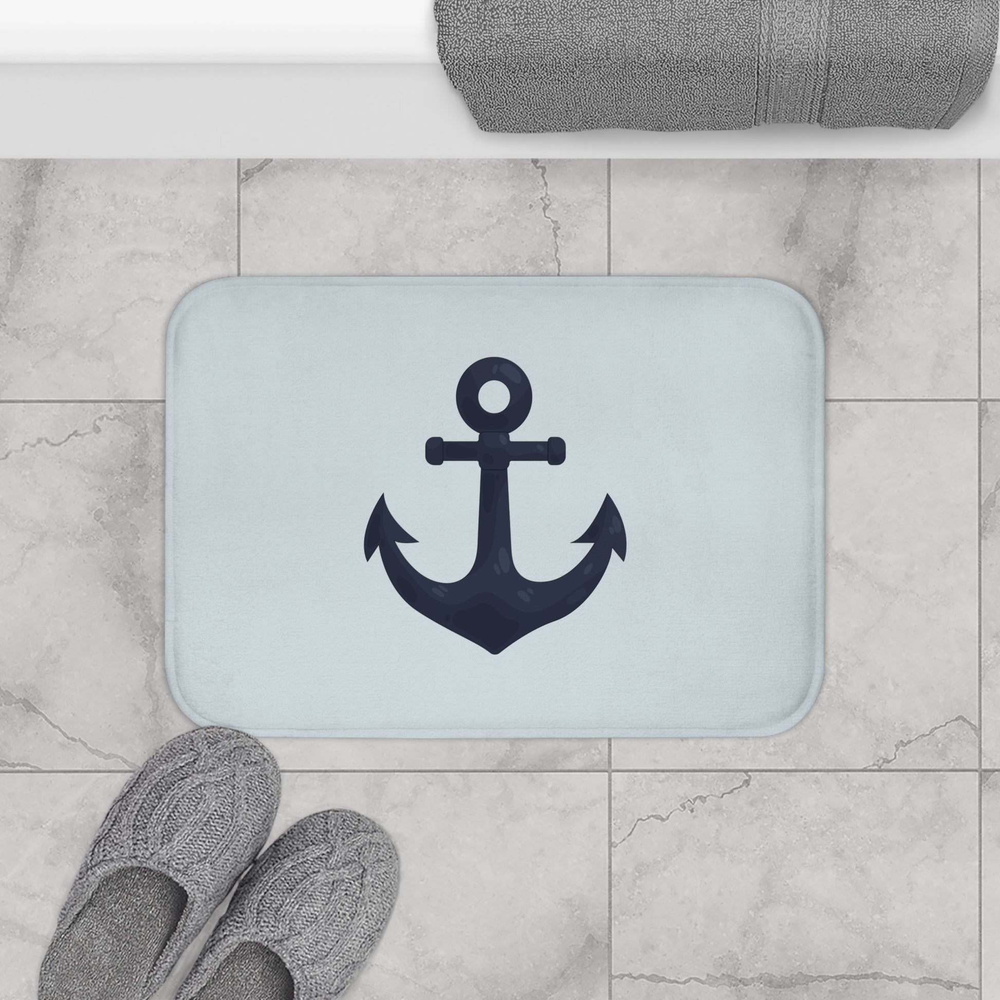 Bath mat with anchor design on a tiled bathroom floor