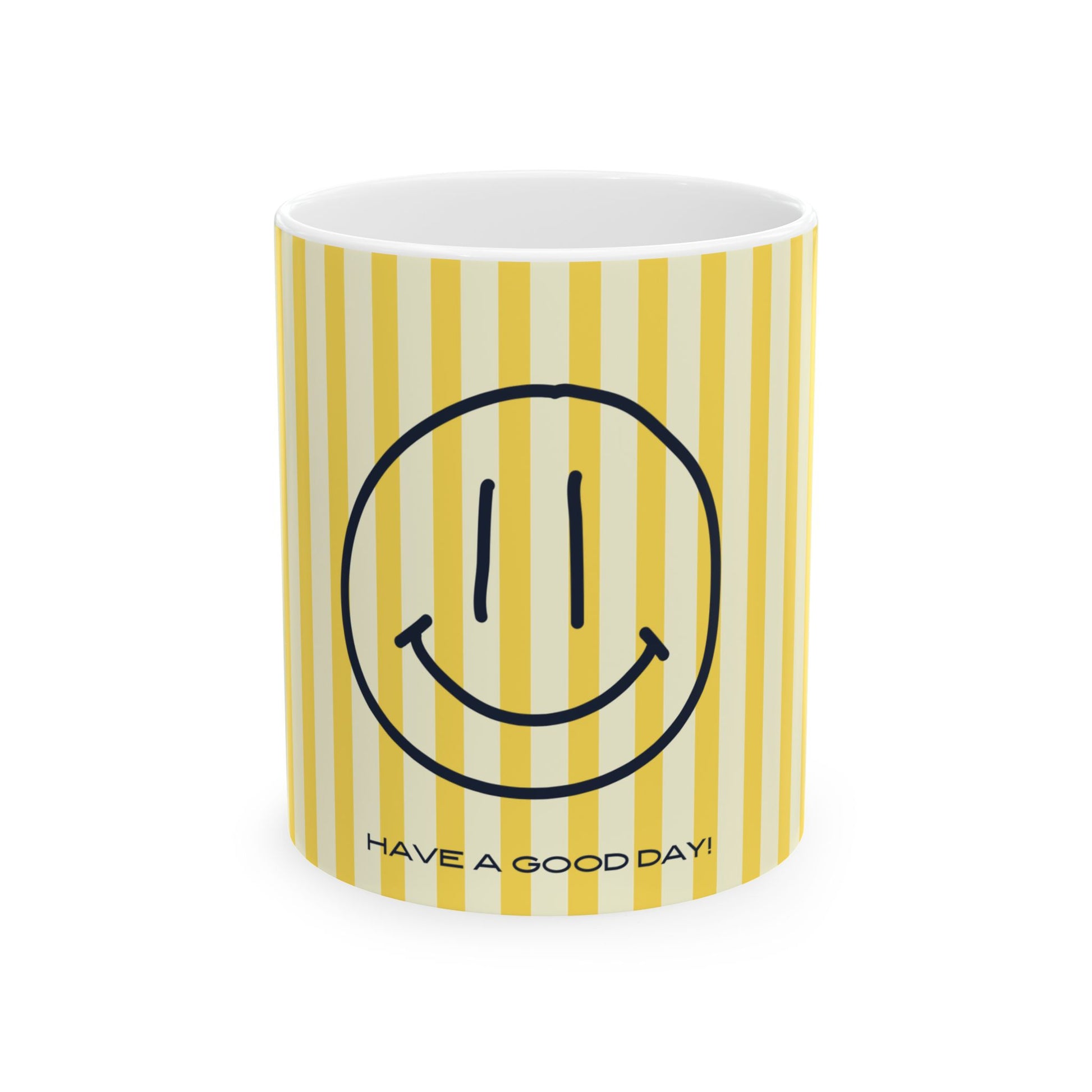 A white ceramic mug with yellow and cream vertical stripes, featuring a black smiley face graphic and the text 'HAVE A GOOD DAY!' printed near the bottom.