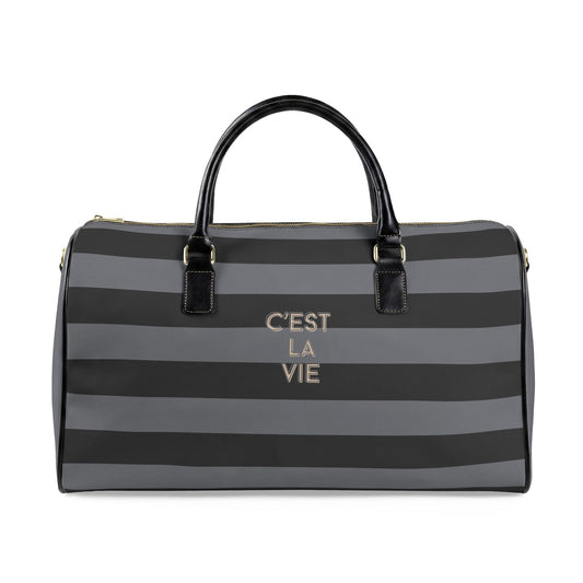 Black and gray striped duffel bag with 'C'EST LA VIE' text on a white background