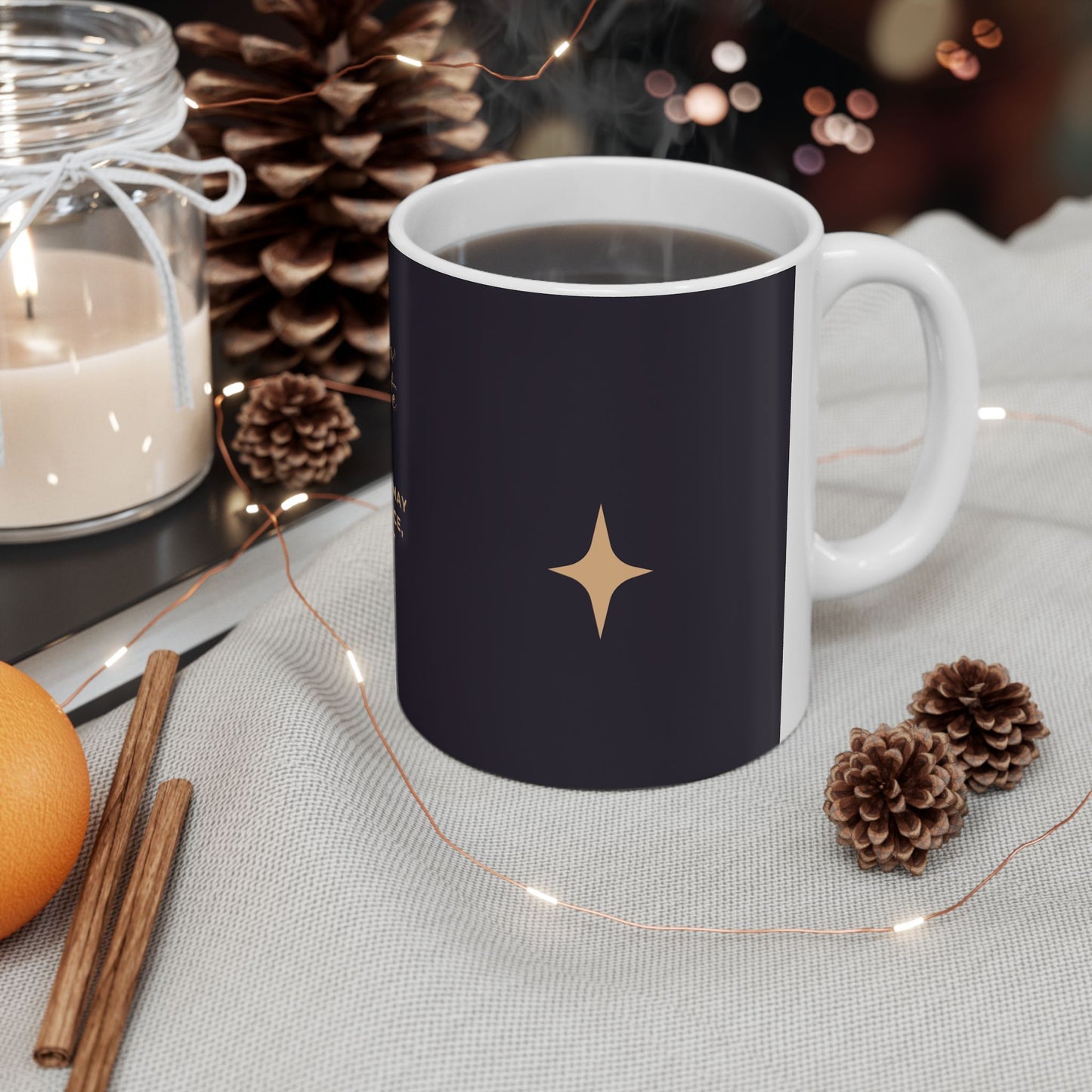Navy mug with a gold star design on a table with decorative items