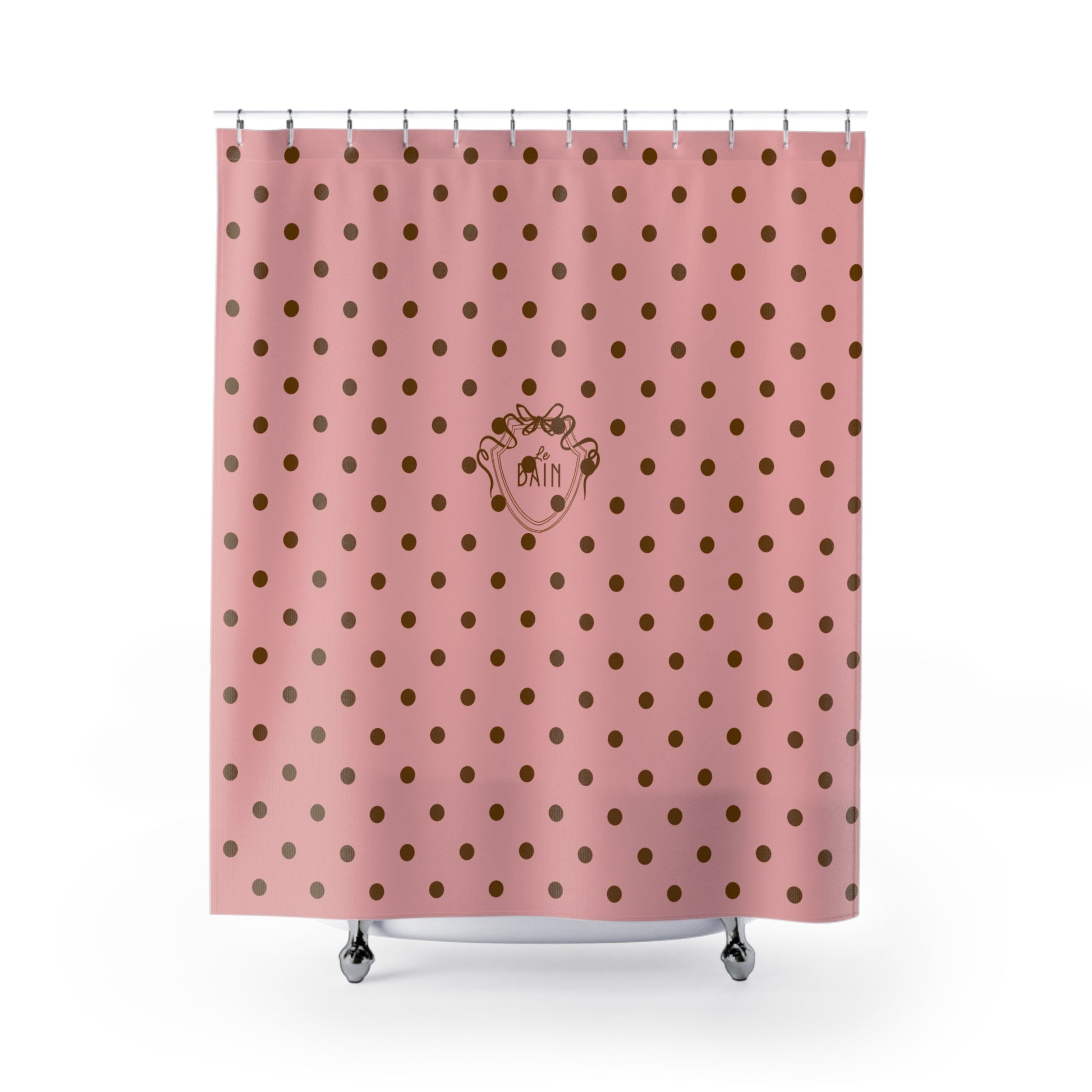 Pink shower curtain with gold polka dots and a logo on a white background