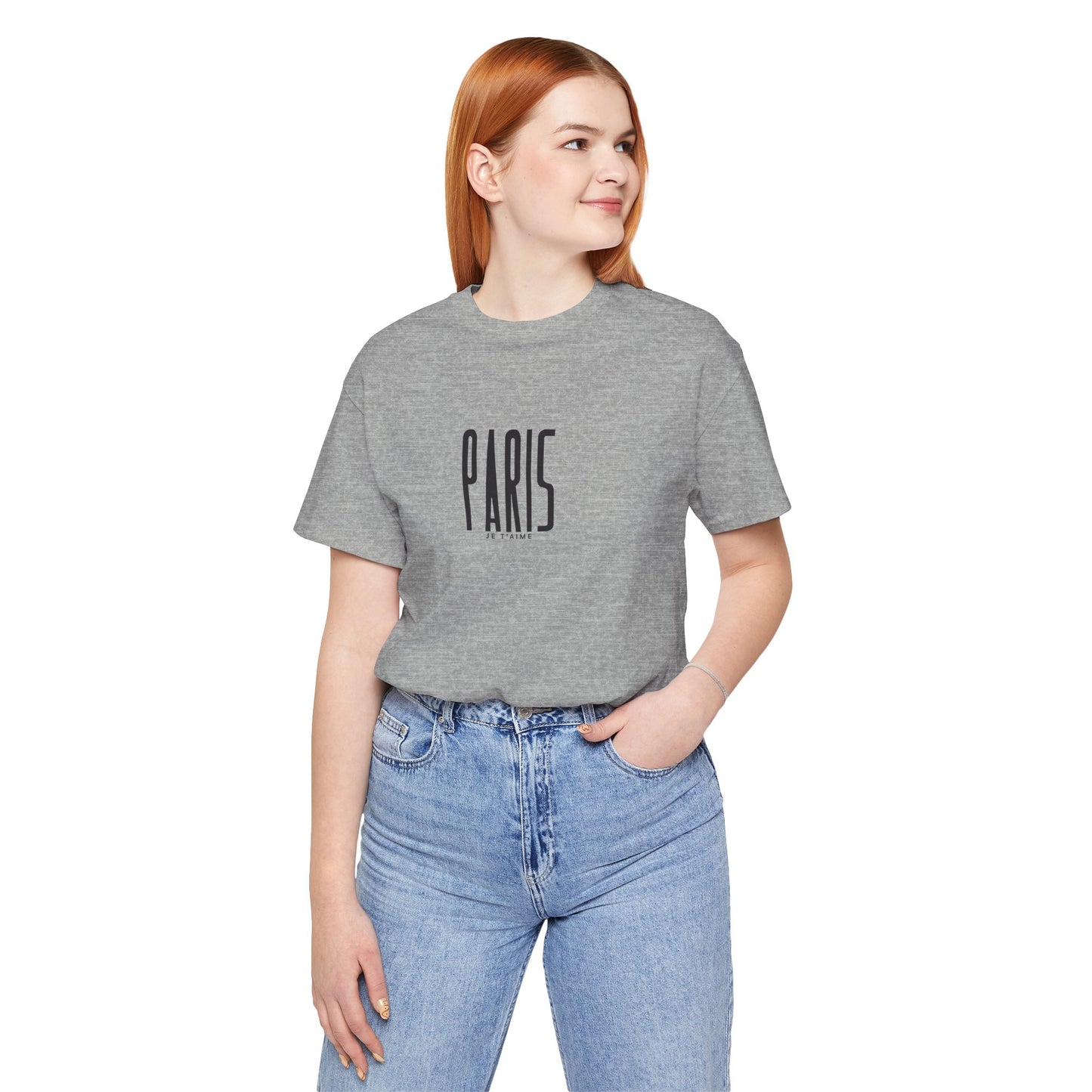 Person wearing a gray t-shirt with 'PARIS' text and blue jeans on a white background
