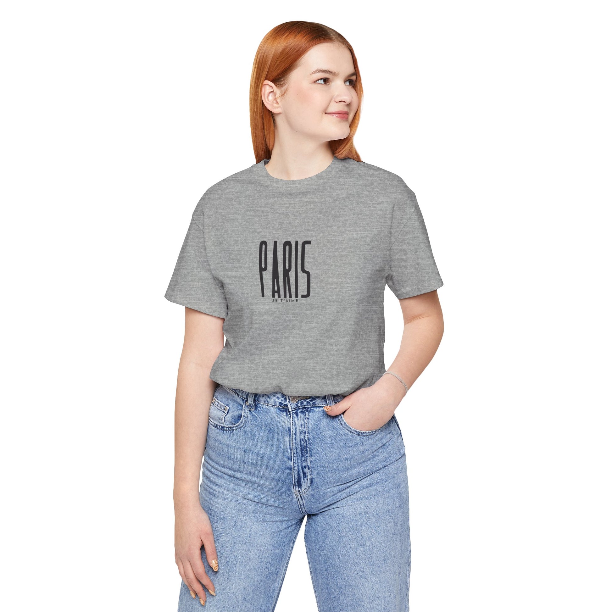 Person wearing a gray t-shirt with 'PARIS' text and blue jeans on a white background