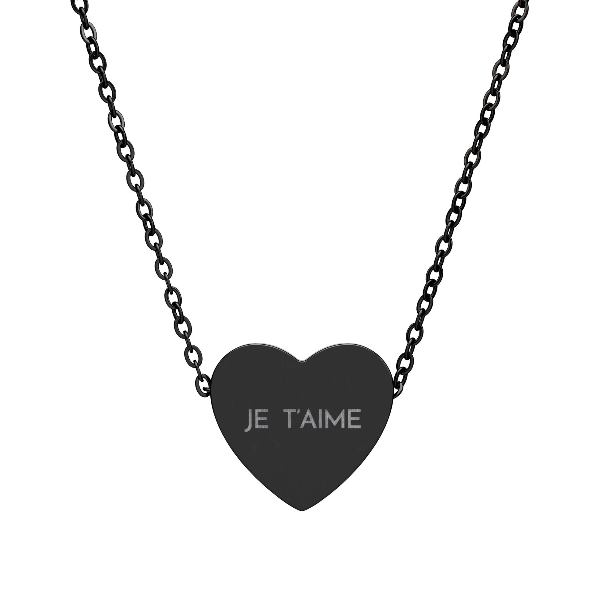 Black heart-shaped pendant with 'JE T'AIME' engraving on a chain against a white background