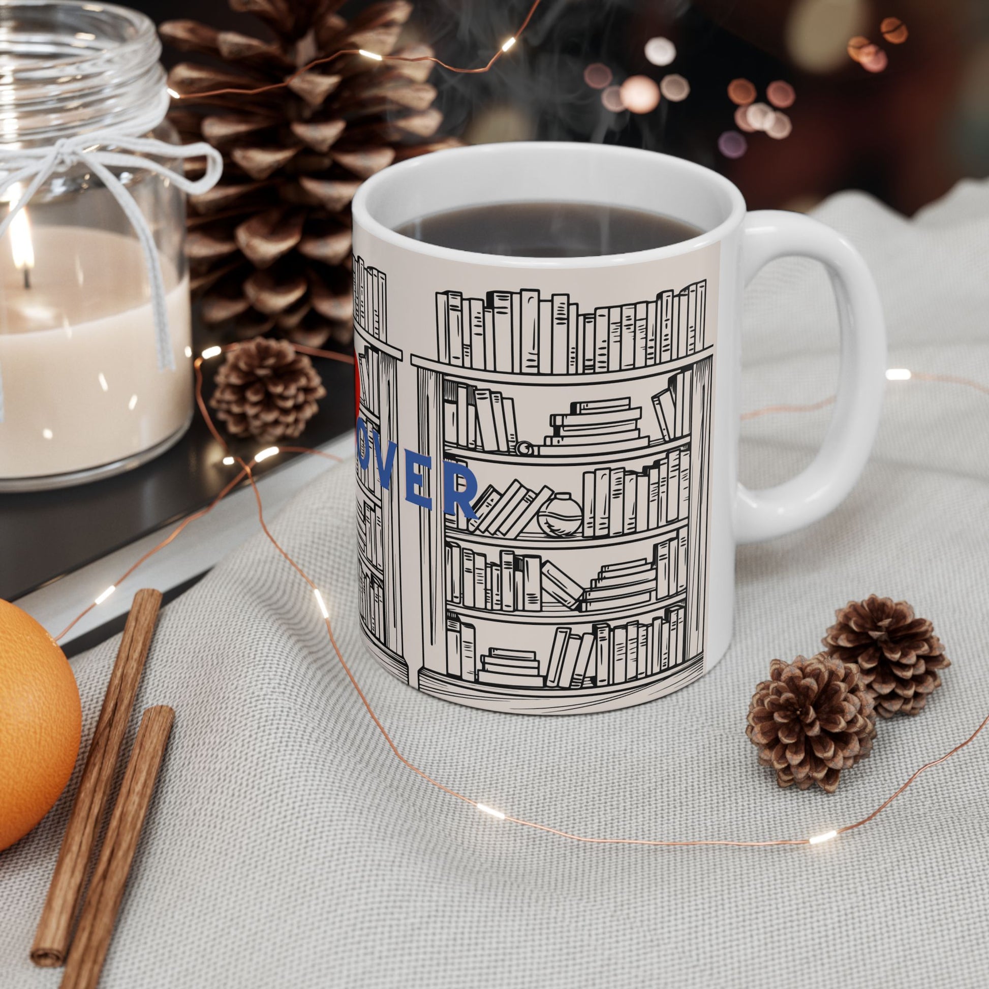 Mug with bookshelf design on a table with candles and pinecones