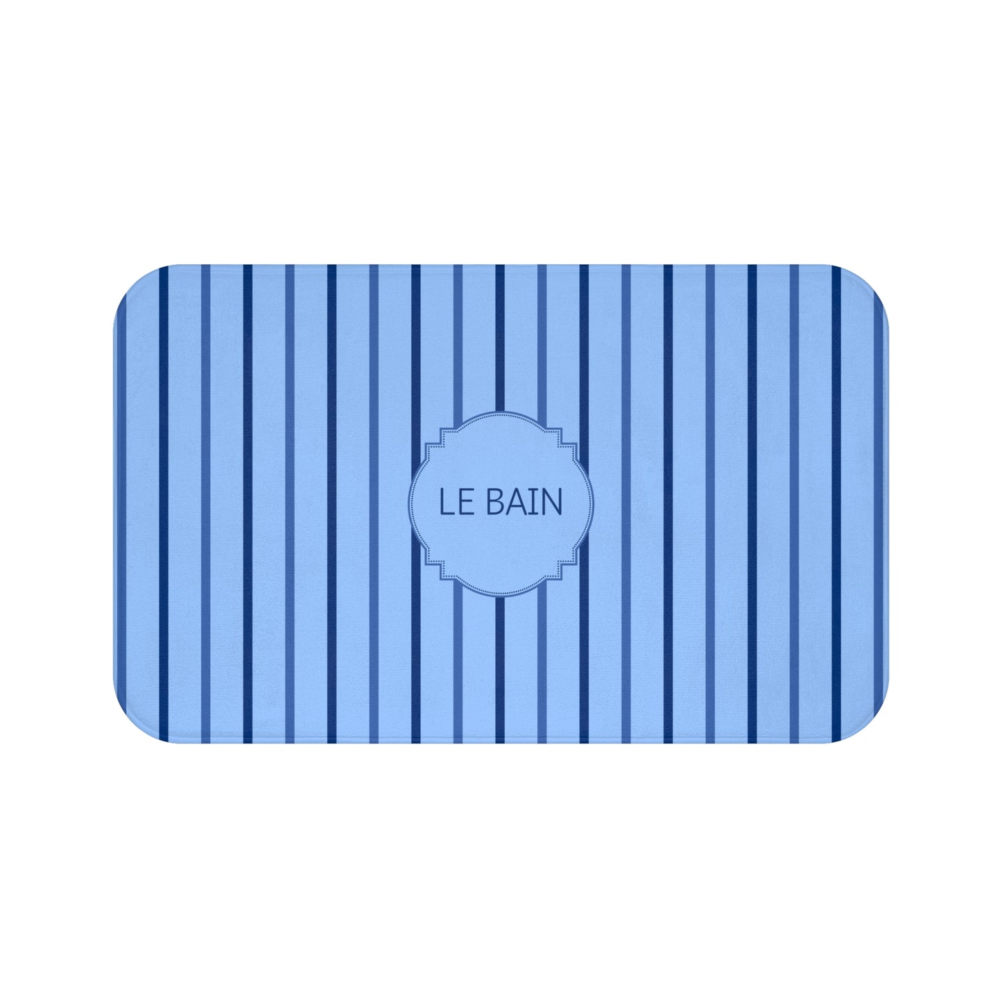 A rectangular bath mat with rounded corners, featuring a light blue and navy blue vertical stripe pattern and a central oval label that reads 'LE BAIN'.