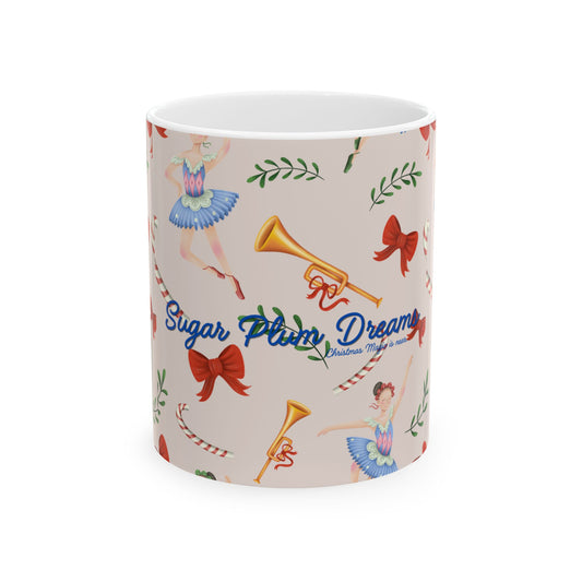A white ceramic mug featuring a vintage-style holiday pattern with ballerinas, red bows, candy canes, and gold brass instruments on a beige background, with the text 'Sugar Plum Dreams' printed on the front.