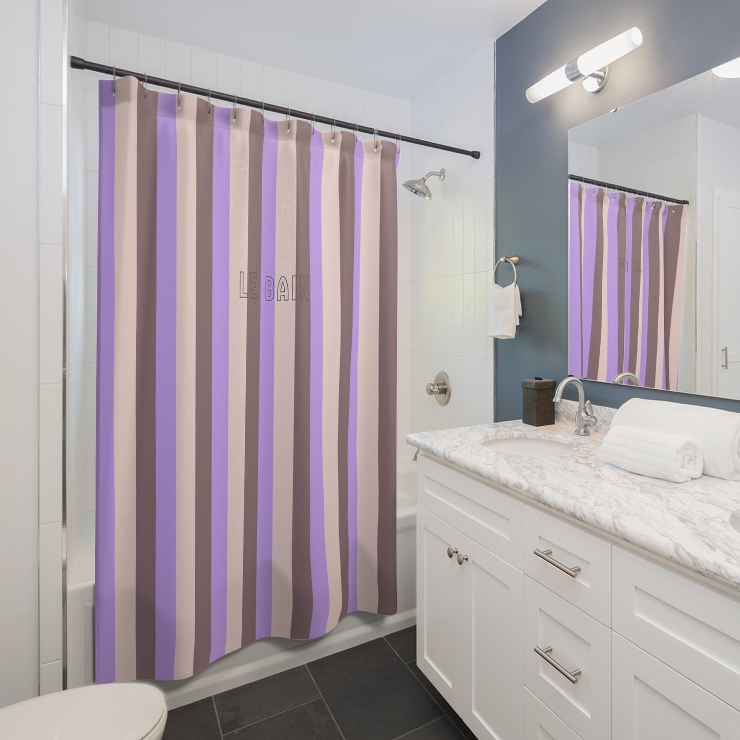 Bathroom with a striped shower curtain, sink, and mirror.