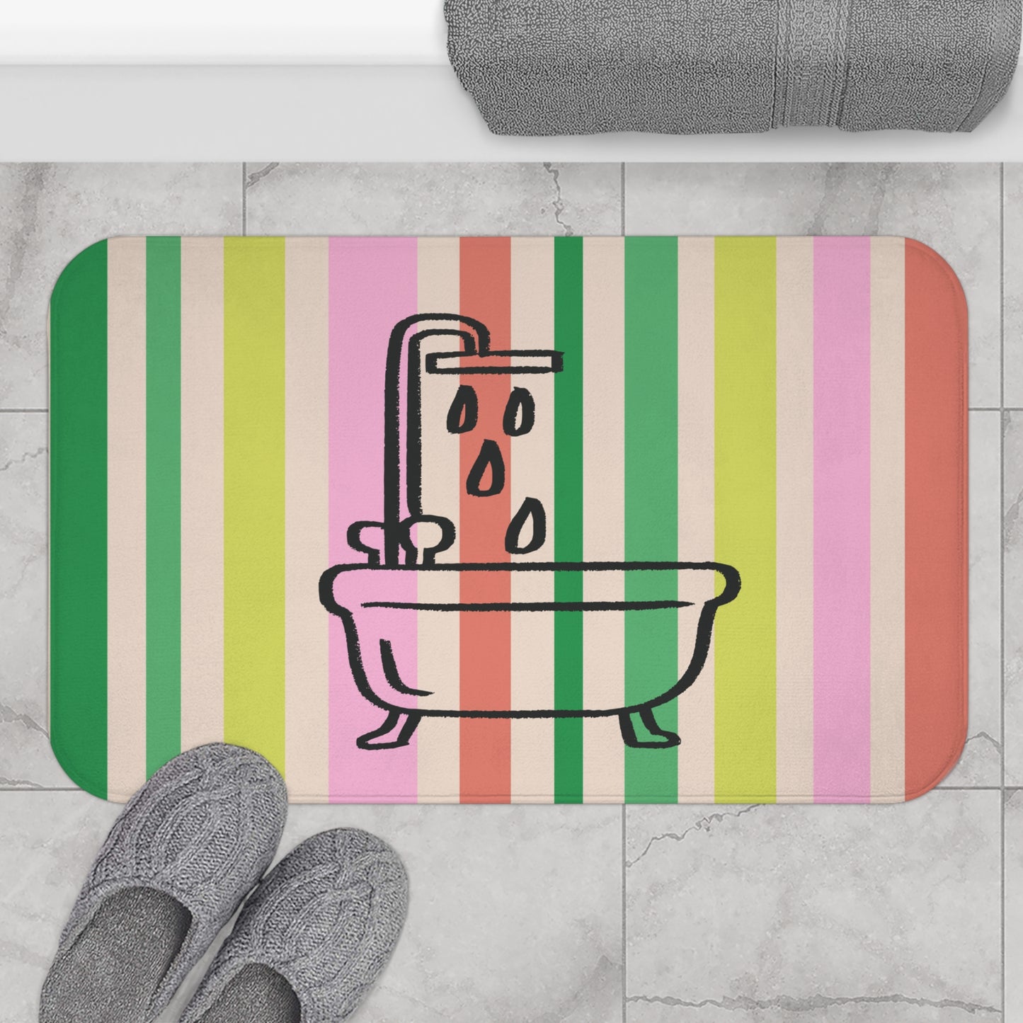 Striped bath mat with bathtub and shower design on a tiled floor.