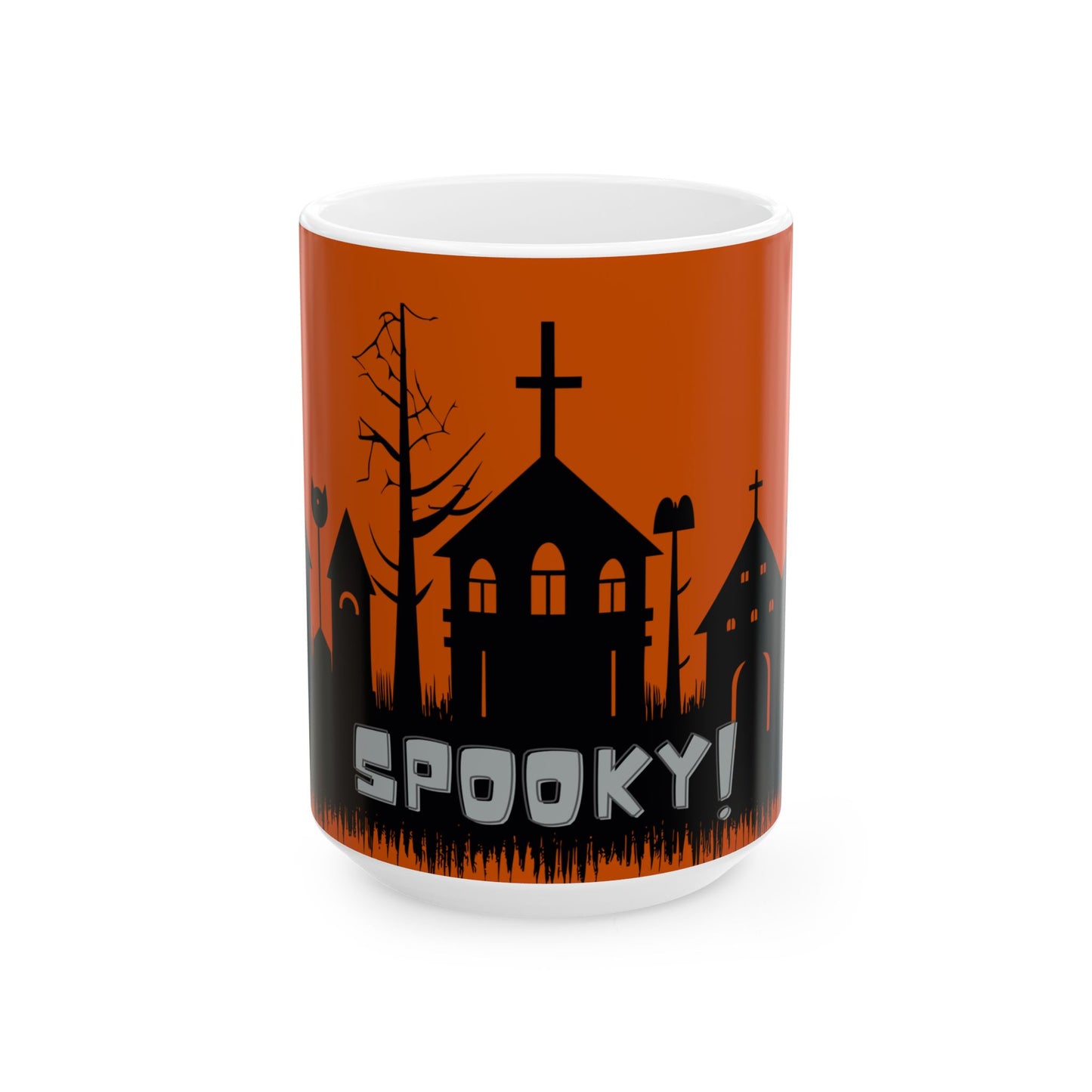 A white ceramic mug featuring a Halloween-themed graphic with a black silhouette of spooky houses, a bare tree, and the word 'SPOOKY!' in white text against an orange background.