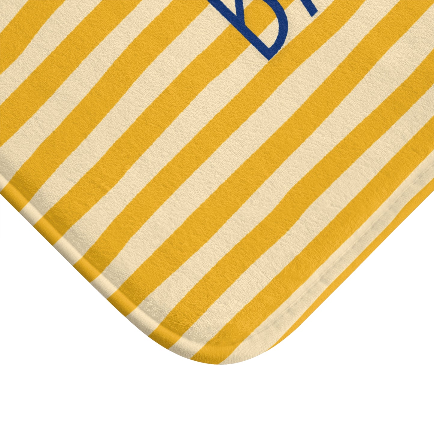 Close-up of a yellow and white striped fabric with a blue logo.