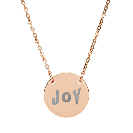 Rose gold necklace with a round pendant engraved with 'Joy' on a white background